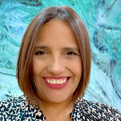 Paola Yepes, a professional and smiling woman with a colorful, abstract background.